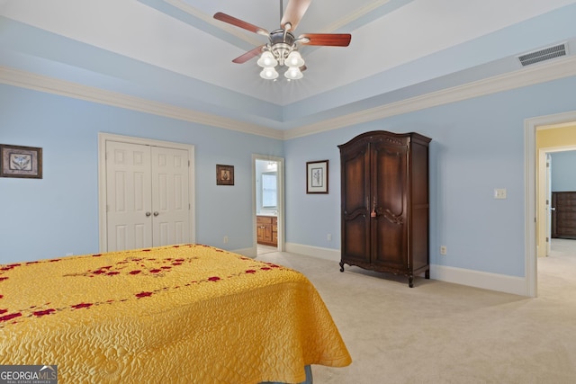 bedroom featuring light colored carpet, a raised ceiling, visible vents, and baseboards