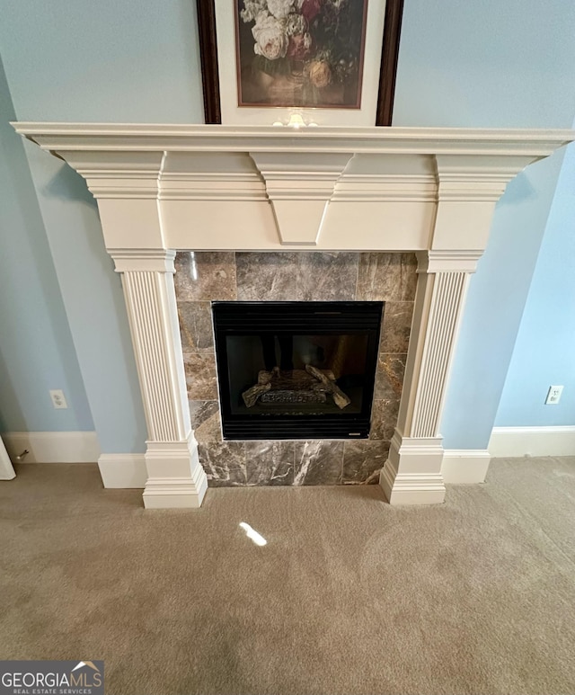 room details featuring carpet, ornate columns, baseboards, and a tiled fireplace