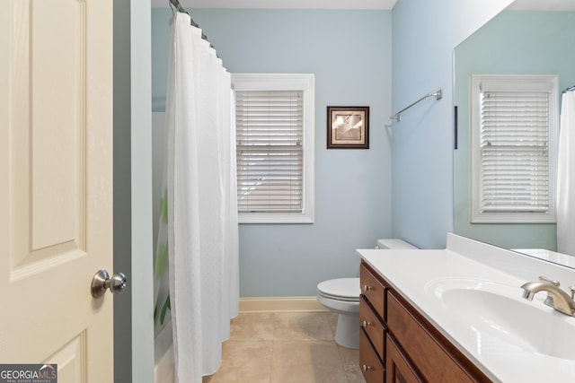 bathroom with baseboards, a shower with shower curtain, toilet, tile patterned floors, and vanity