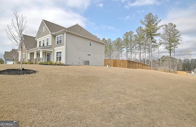 view of side of home with fence and central air condition unit