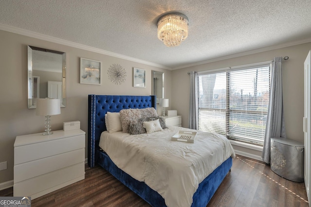 bedroom featuring a textured ceiling, dark wood-type flooring, an inviting chandelier, and crown molding