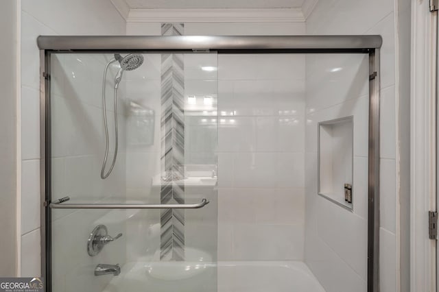 bathroom featuring ornamental molding and shower / bath combination with glass door