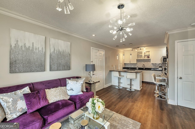 living room featuring a notable chandelier, crown molding, a textured ceiling, and dark wood-style flooring