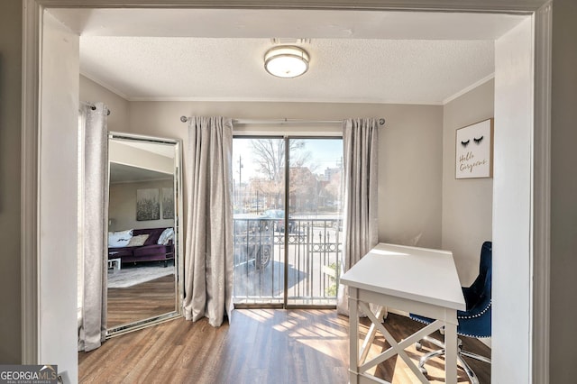 office featuring crown molding, a textured ceiling, and wood finished floors