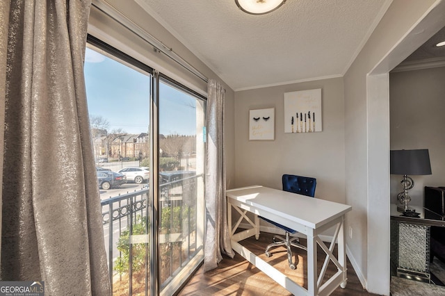 office featuring a textured ceiling, crown molding, and wood finished floors