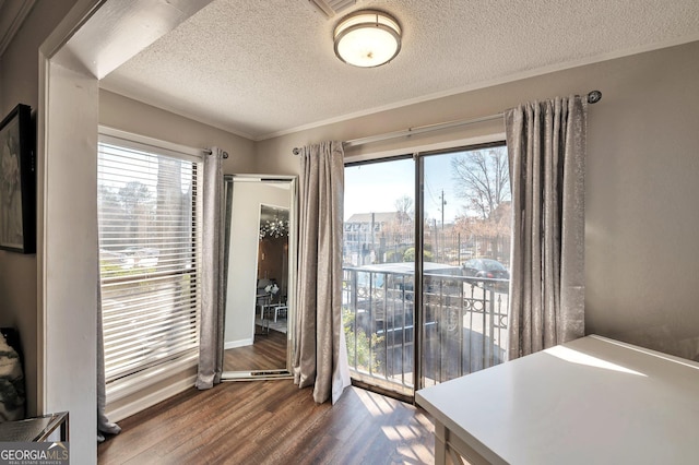 interior space with a healthy amount of sunlight, a textured ceiling, and wood finished floors