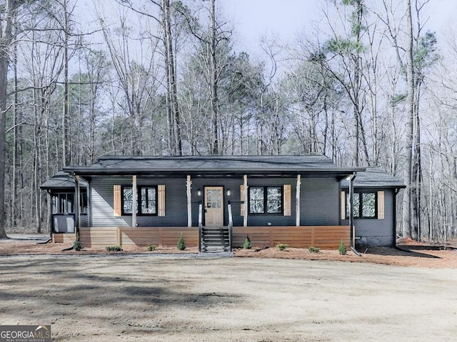 mid-century inspired home with a porch and a front lawn