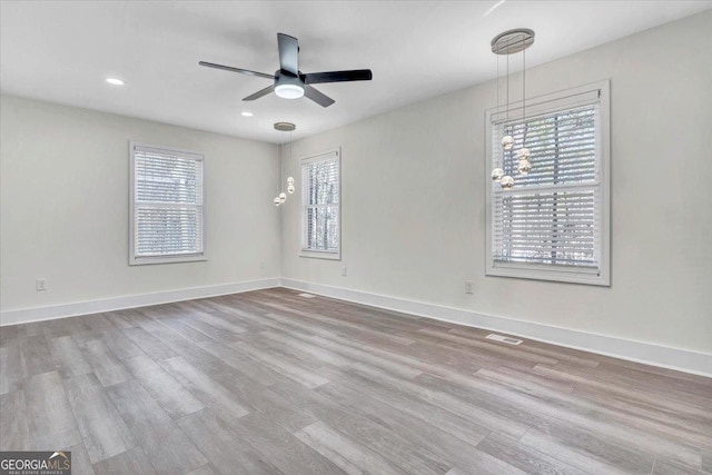 empty room with light wood-style floors, ceiling fan, baseboards, and recessed lighting