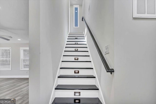 stairs featuring ceiling fan, baseboards, wood finished floors, and recessed lighting