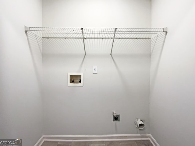 washroom with laundry area, hookup for a washing machine, baseboards, and hookup for an electric dryer