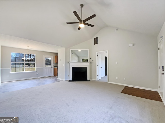 unfurnished living room with light colored carpet, visible vents, a fireplace with flush hearth, high vaulted ceiling, and ceiling fan with notable chandelier