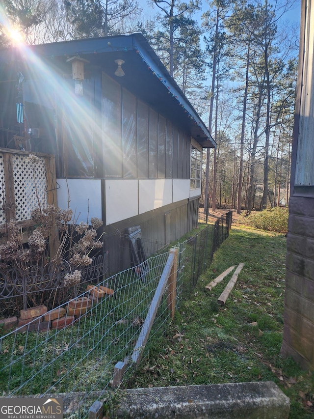 view of property exterior with a sunroom
