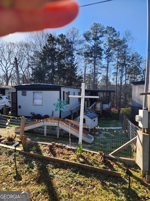 rear view of house with fence