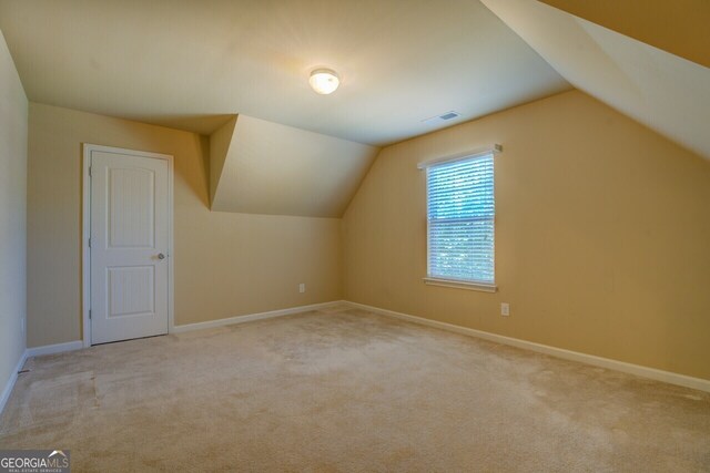 1186 Diamond Xing, Mcdonough, GA 30252 - additional living space featuring lofted ceiling, carpet flooring, and baseboards