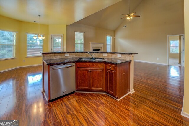 1186 Diamond Xing, Mcdonough, GA 30252 - kitchen featuring dishwasher, open floor plan, a sink, dark wood-style flooring, and a fireplace