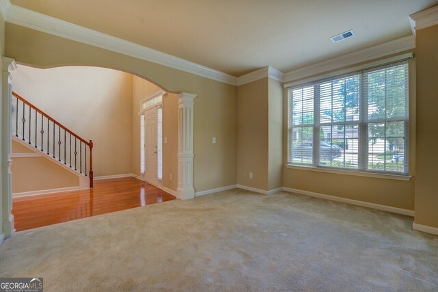 1186 Diamond Xing, Mcdonough, GA 30252 - unfurnished room featuring carpet, ornate columns, crown molding, arched walkways, and baseboards