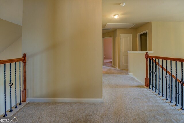 1186 Diamond Xing, Mcdonough, GA 30252 - hallway featuring attic access, light carpet, an upstairs landing, and baseboards