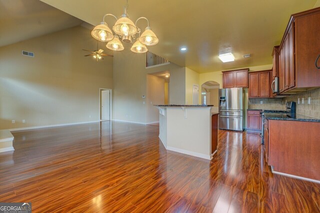 1186 Diamond Xing, Mcdonough, GA 30252 - kitchen featuring appliances with stainless steel finishes, dark wood-type flooring, open floor plan, and arched walkways