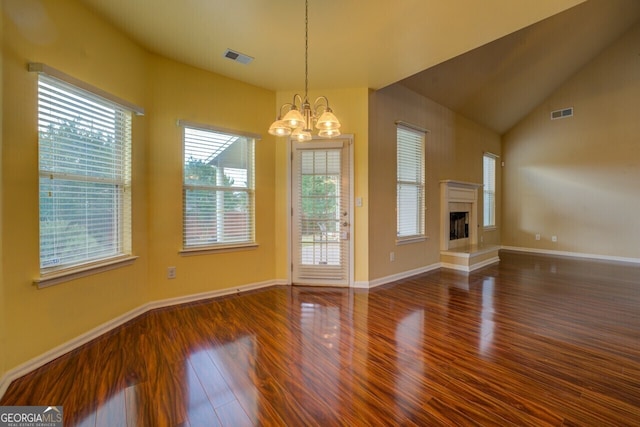 1186 Diamond Xing, Mcdonough, GA 30252 - unfurnished living room with wood finished floors, a chandelier, a fireplace with raised hearth, and baseboards