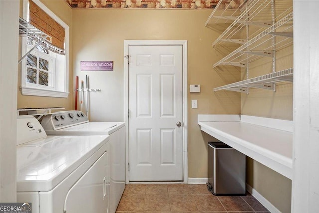 washroom with laundry area, light tile patterned floors, baseboards, and separate washer and dryer