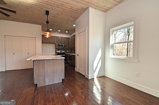 kitchen with wooden ceiling, stainless steel appliances, dark wood-style flooring, a center island, and decorative light fixtures