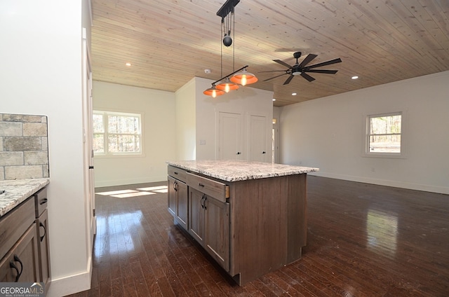 kitchen featuring wood ceiling, decorative light fixtures, dark wood-style flooring, and light stone countertops