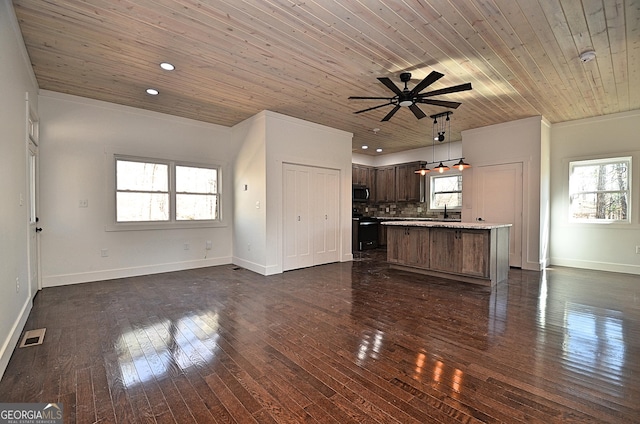 unfurnished living room featuring dark wood-style floors, wooden ceiling, and a healthy amount of sunlight