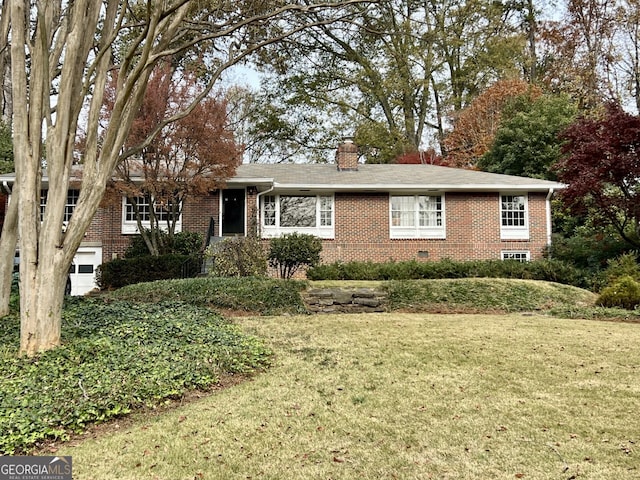 ranch-style home featuring brick siding, a chimney, and a front lawn