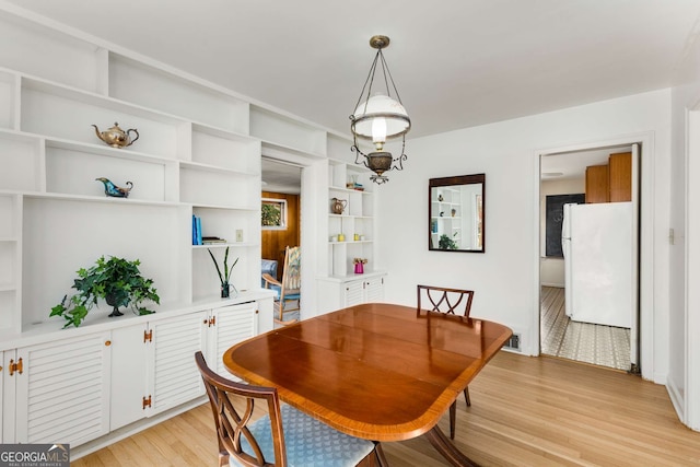 dining space with light wood finished floors