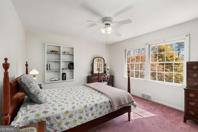 carpeted bedroom featuring ceiling fan and visible vents