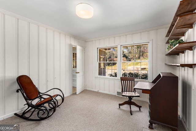 living area with baseboards, carpet flooring, and crown molding