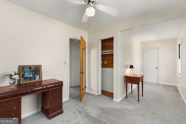 home office with light carpet, baseboards, and a ceiling fan