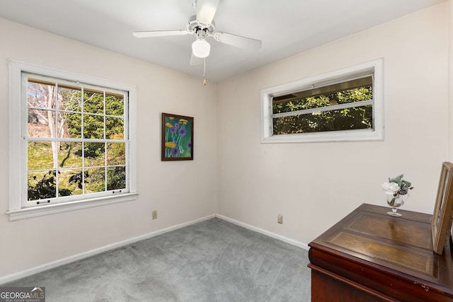 interior space featuring a ceiling fan and baseboards