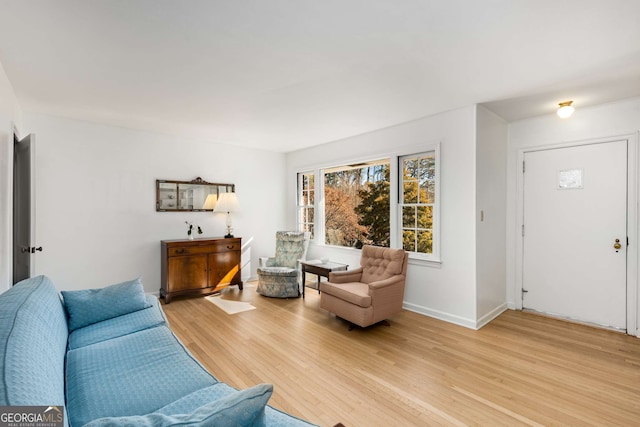 living area with light wood-style floors and baseboards