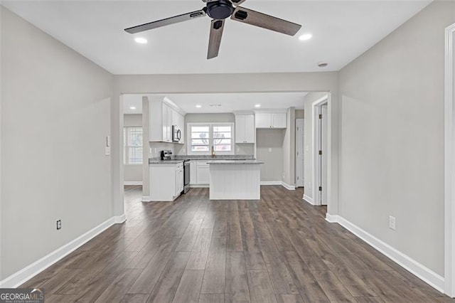 unfurnished living room with ceiling fan, baseboards, dark wood-type flooring, and recessed lighting