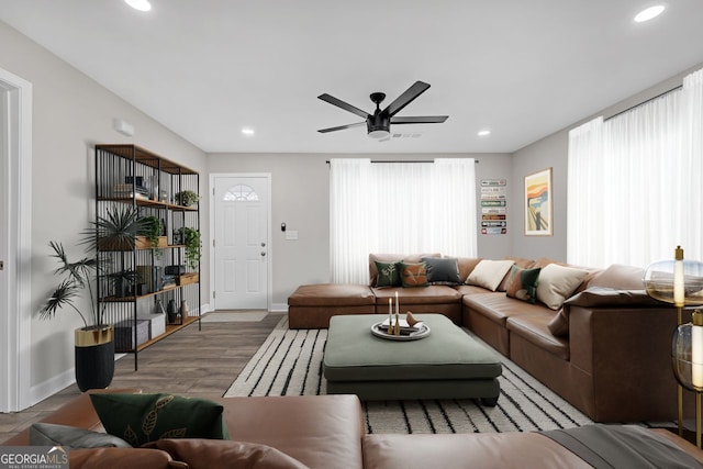 living area featuring ceiling fan, baseboards, wood finished floors, and recessed lighting