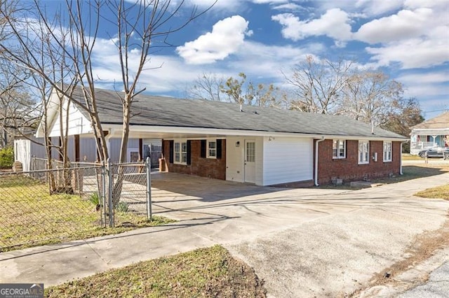 ranch-style house featuring driveway, crawl space, fence, a carport, and brick siding