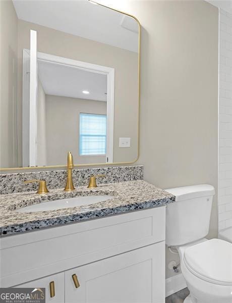 bathroom featuring toilet and vanity