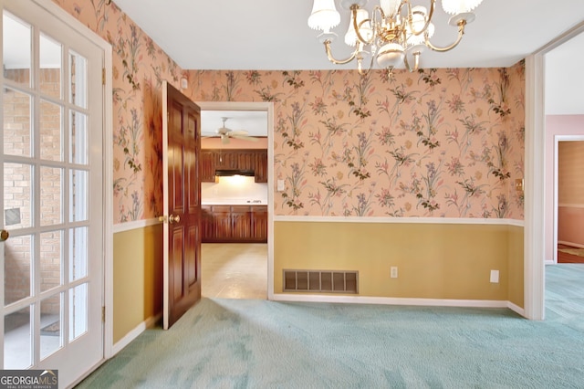 unfurnished dining area featuring wallpapered walls, visible vents, and carpet flooring