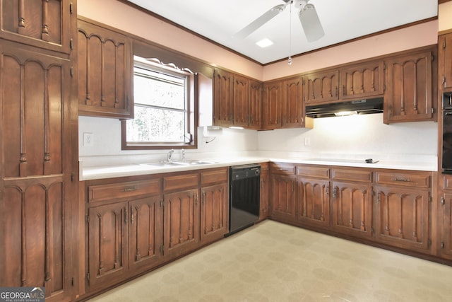 kitchen with light floors, under cabinet range hood, light countertops, black appliances, and a sink