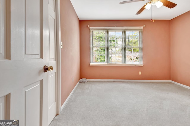 unfurnished room featuring baseboards, a ceiling fan, and light colored carpet