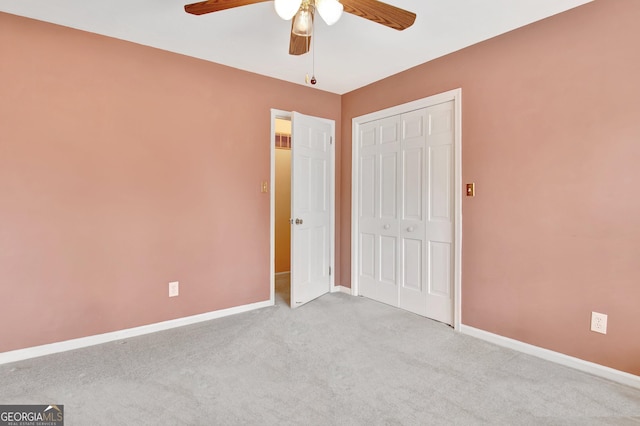 unfurnished bedroom with light carpet, ceiling fan, baseboards, and a closet