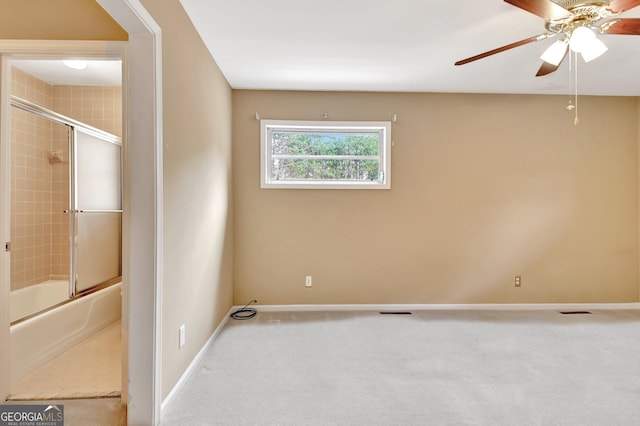 spare room with light carpet, visible vents, baseboards, and a ceiling fan