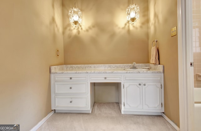 bathroom with vanity and baseboards