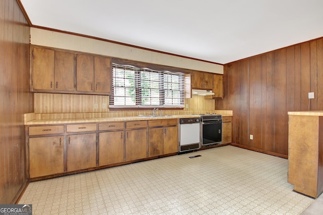 kitchen featuring light countertops, light floors, white dishwasher, and a sink