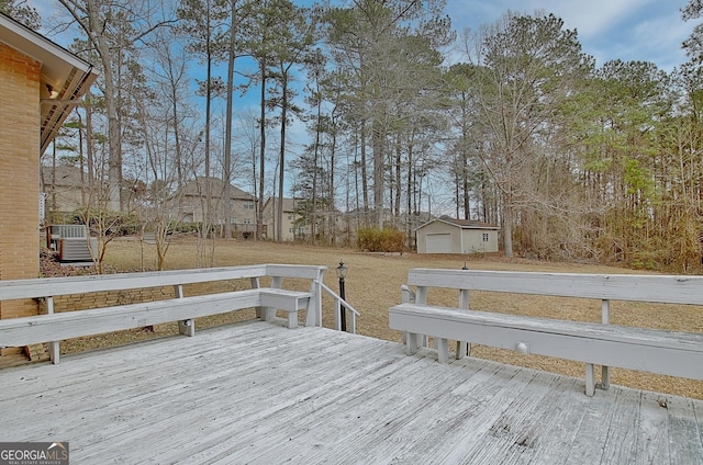 deck featuring a garage and an outdoor structure