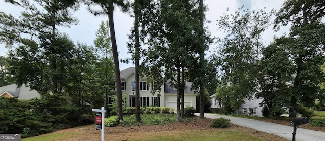 obstructed view of property featuring driveway