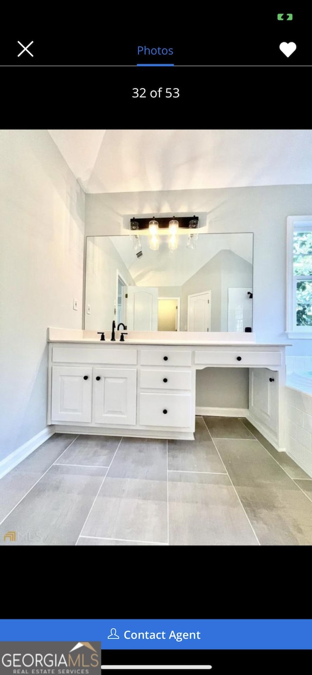 bathroom featuring tile patterned flooring and vanity