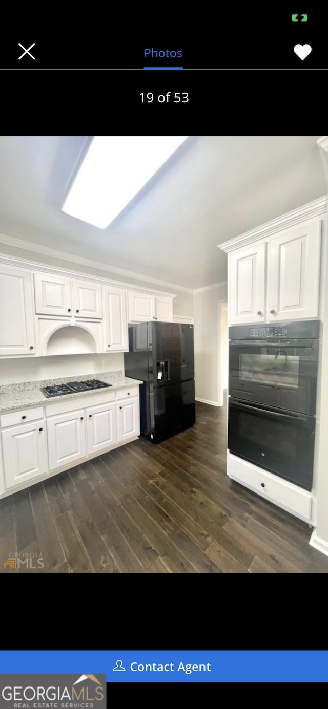 kitchen featuring black appliances, dark wood finished floors, and white cabinetry