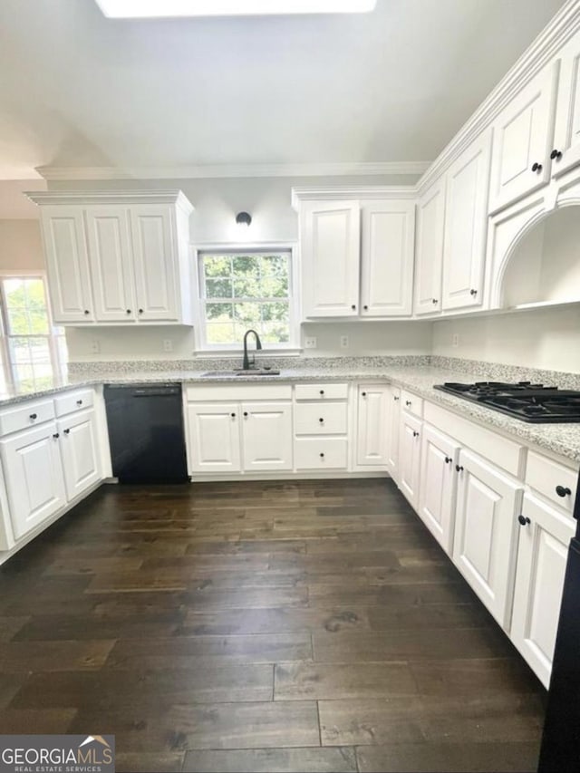 kitchen featuring black appliances, a sink, and white cabinets